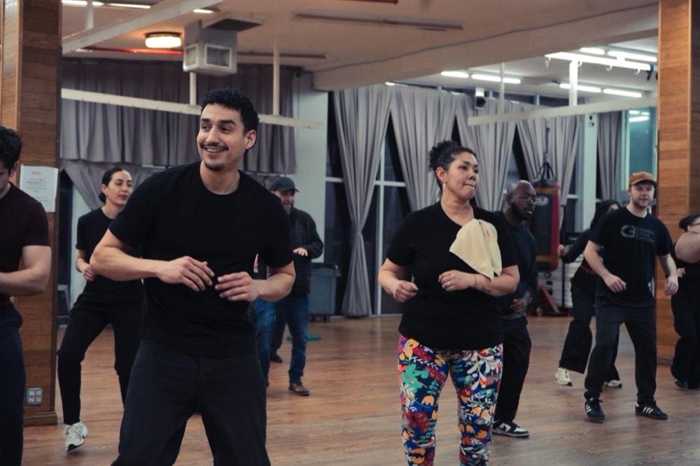 A full beginner Mambo class practising together in the studio at 207 Johnson Ave, Brooklyn
