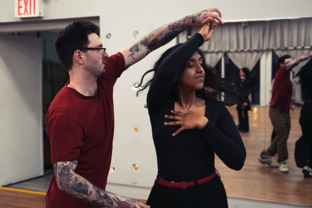 Two dancers mid-turn during intermediate partnerwork at NYC Salsa Dance in Brooklyn